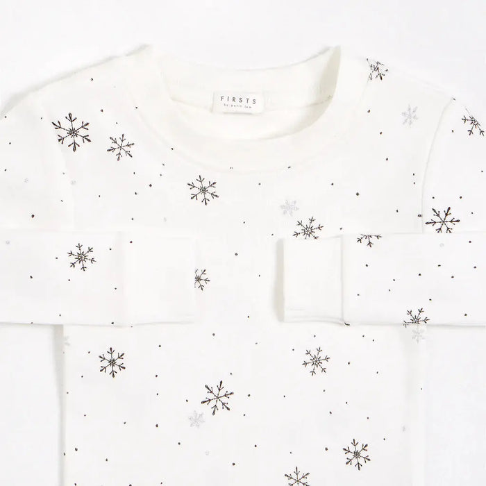 Close-up of Petit Lem baby girls snowflake pajamas with soft ribbed cotton fabric and elastic cuffs.