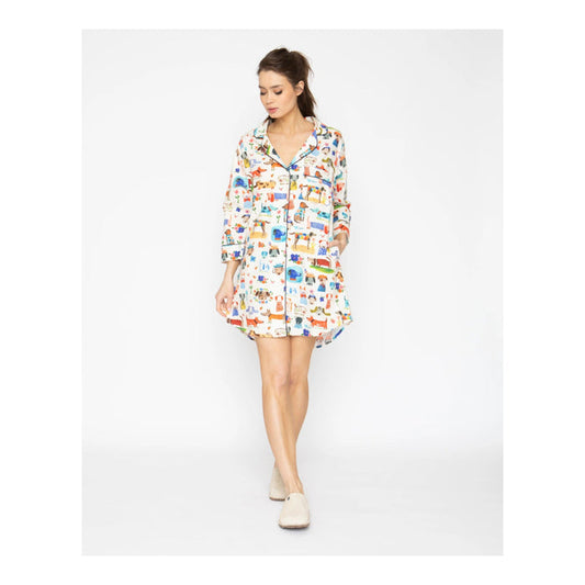 Woman wearing a colorful patterned shirt dress on a white background